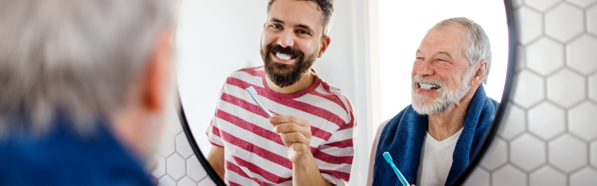 elderly and caregiver brushing teeth